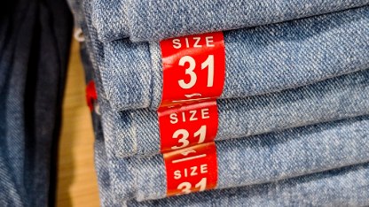 Size information stickers on pants sold in clothing stores.