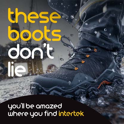 A pair of rugged boots surrounded by splashing water with an offshore platform in the background